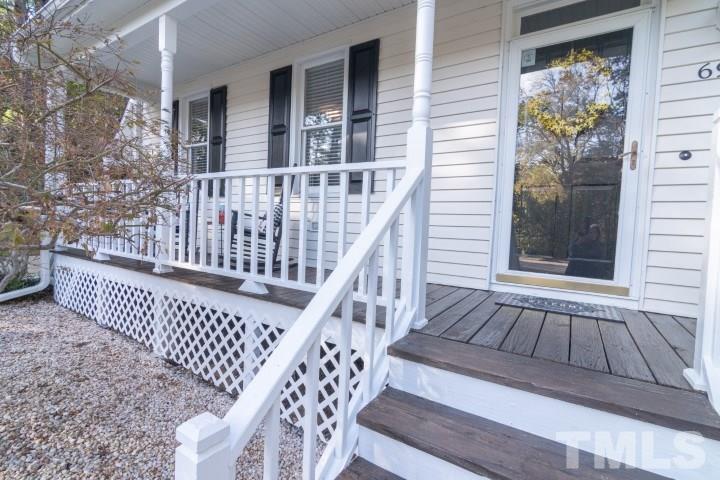 6940 Spring Drive Raleigh, NC 27613 - Photo 2 of 18 a view of wooden balcony with two chairs