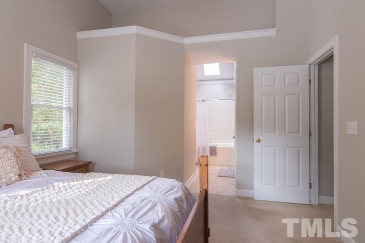 6940 Spring Drive Raleigh, NC 27613 - Photo 12 of 18 a bedroom with a bed and a window