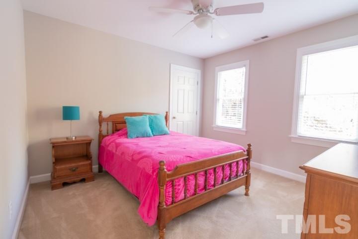6940 Spring Drive Raleigh, NC 27613 - Photo 16 of 18 a bedroom with a bed and window