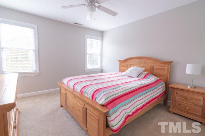 6940 Spring Drive Raleigh, NC 27613 - Photo 17 of 18 a bedroom with a bed and a window
