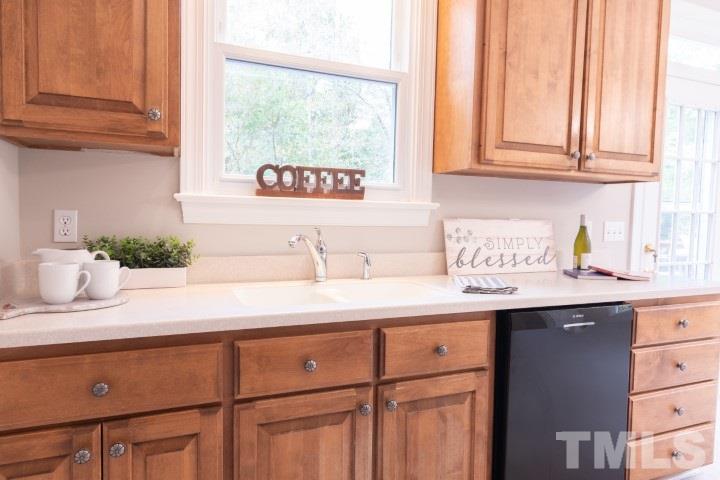 6940 Spring Drive Raleigh, NC 27613 - Photo 10 of 18 a kitchen with a sink and cabinets