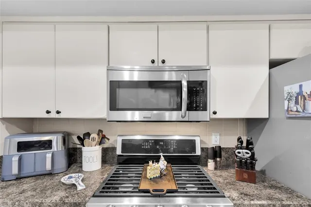 a stove top oven sitting inside of a kitchen