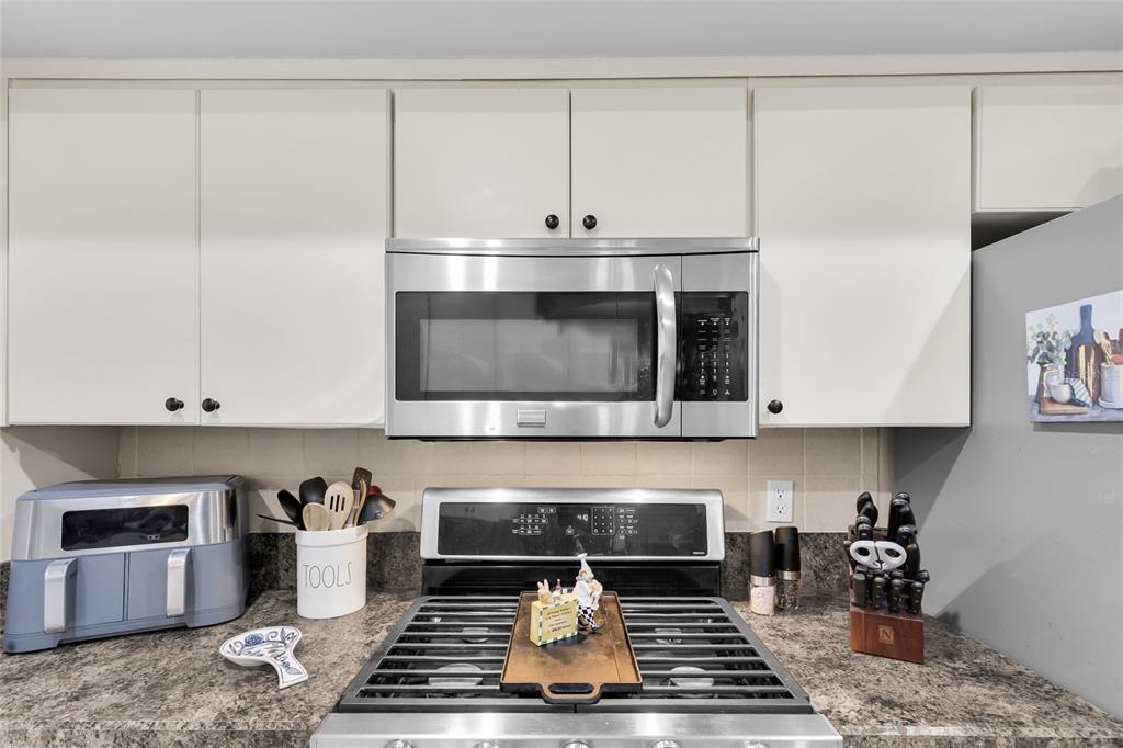 5138 Indian Ocean Loop Tavares, FL 32778 - Photo 17 of 35 a stove top oven sitting inside of a kitchen
