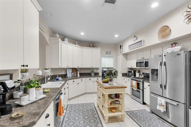 a kitchen with a sink appliances and cabinets