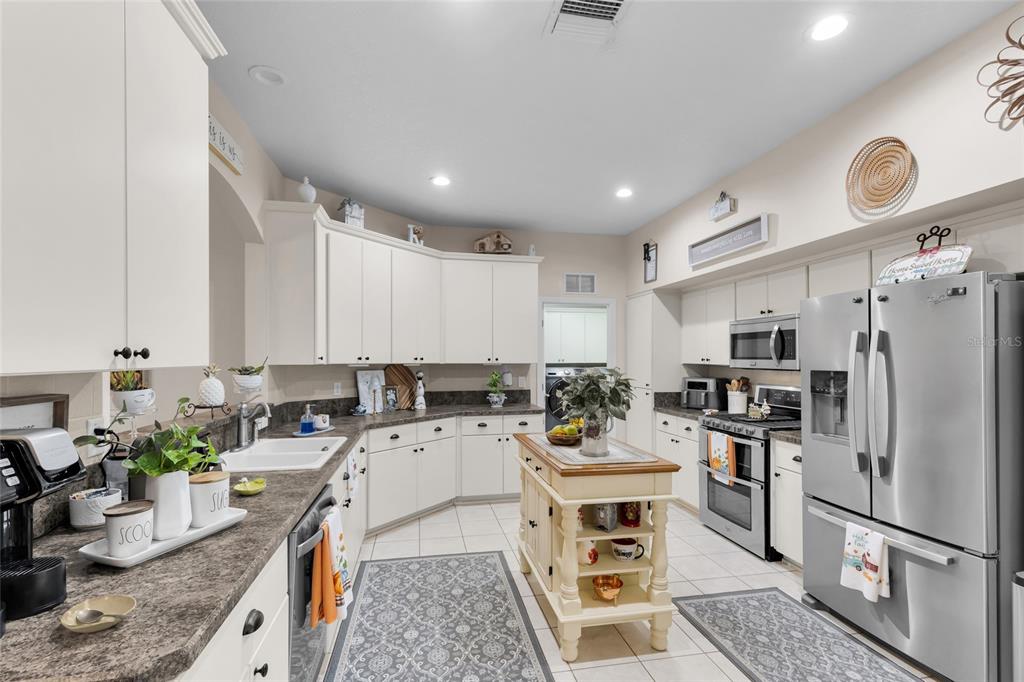 5138 Indian Ocean Loop Tavares, FL 32778 - Photo 19 of 35 a kitchen with a sink appliances and cabinets