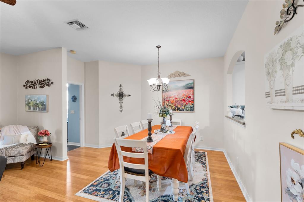 5138 Indian Ocean Loop Tavares, FL 32778 - Photo 22 of 35 a dining room with furniture and wooden floor