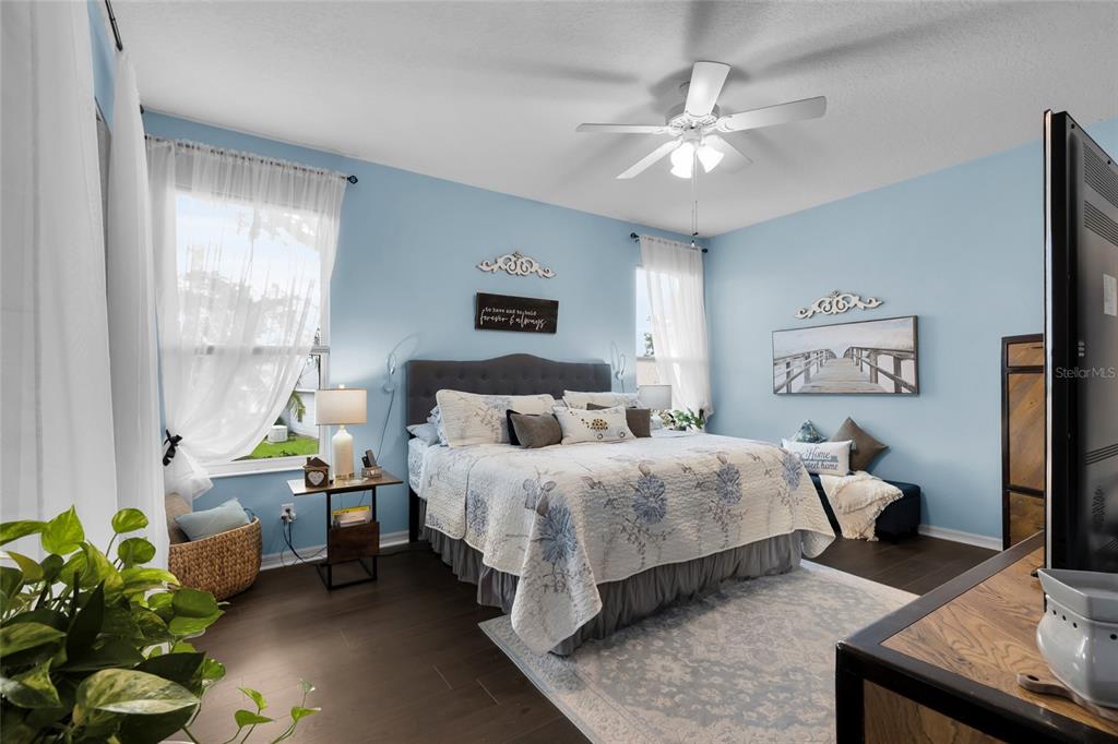 5138 Indian Ocean Loop Tavares, FL 32778 - Photo 23 of 35 a bedroom with a bed mirror and window