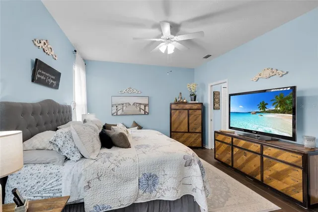 a bedroom with a bed and a flat screen tv