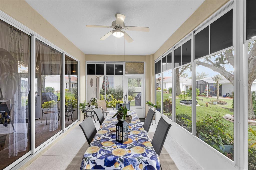 5138 Indian Ocean Loop Tavares, FL 32778 - Photo 30 of 35 a living room with furniture and a floor to ceiling window