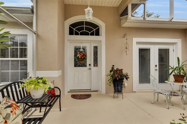 a living room with furniture and flowers