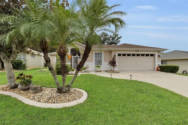 a front view of a house with a garden and plants