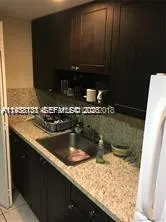 a kitchen with a sink and a stove