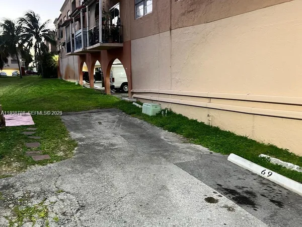 a view of a street with a big yard