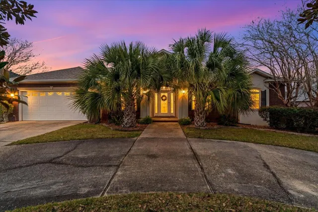 a view of a house with palm trees