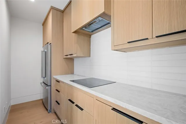a large white kitchen with a stove a sink and dishwasher