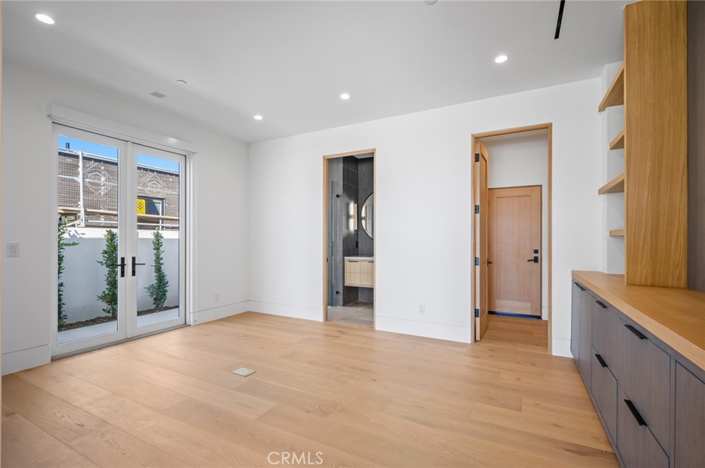 4607 Dorchester Road Corona del Mar, CA 92625 - Photo 22 of 34 a view of an empty room with wooden floor and a bathroom
