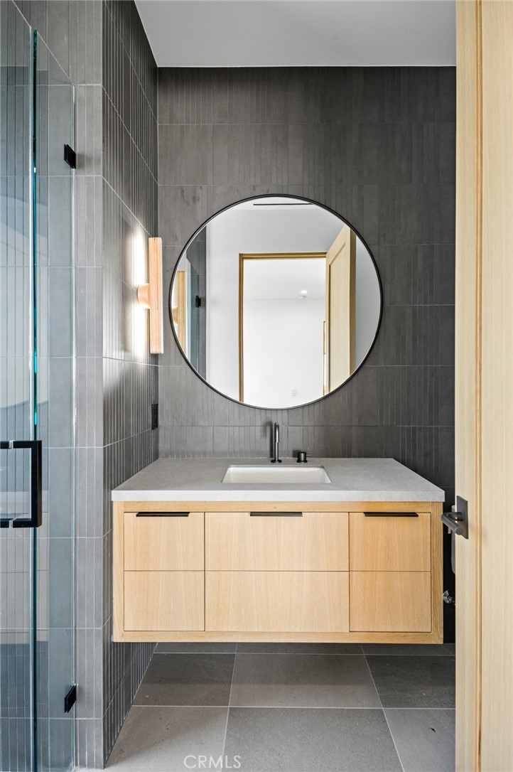 4607 Dorchester Road Corona del Mar, CA 92625 - Photo 23 of 34 a bathroom with a sink a mirror and a shower