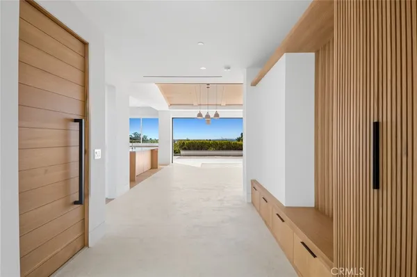 a view of a hallway with kitchen and refrigerator