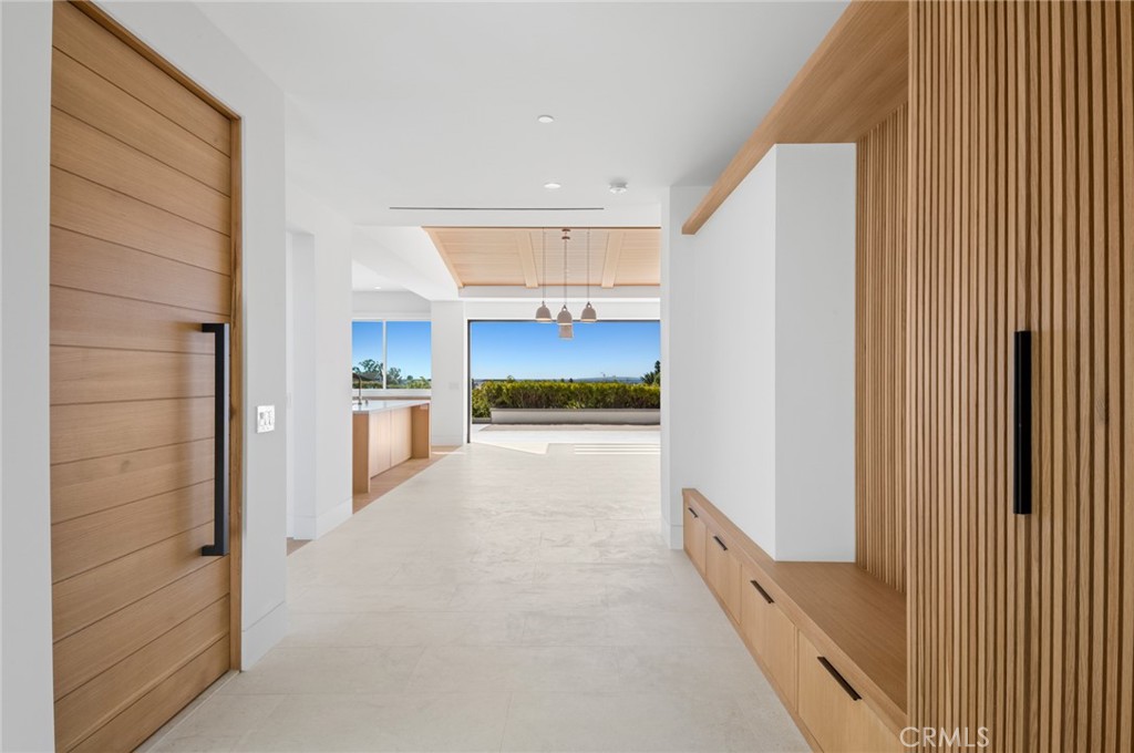 4607 Dorchester Road Corona del Mar, CA 92625 - Photo 3 of 34 a view of a hallway with kitchen and refrigerator