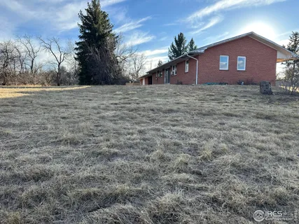 a view of a house with a yard and porch
