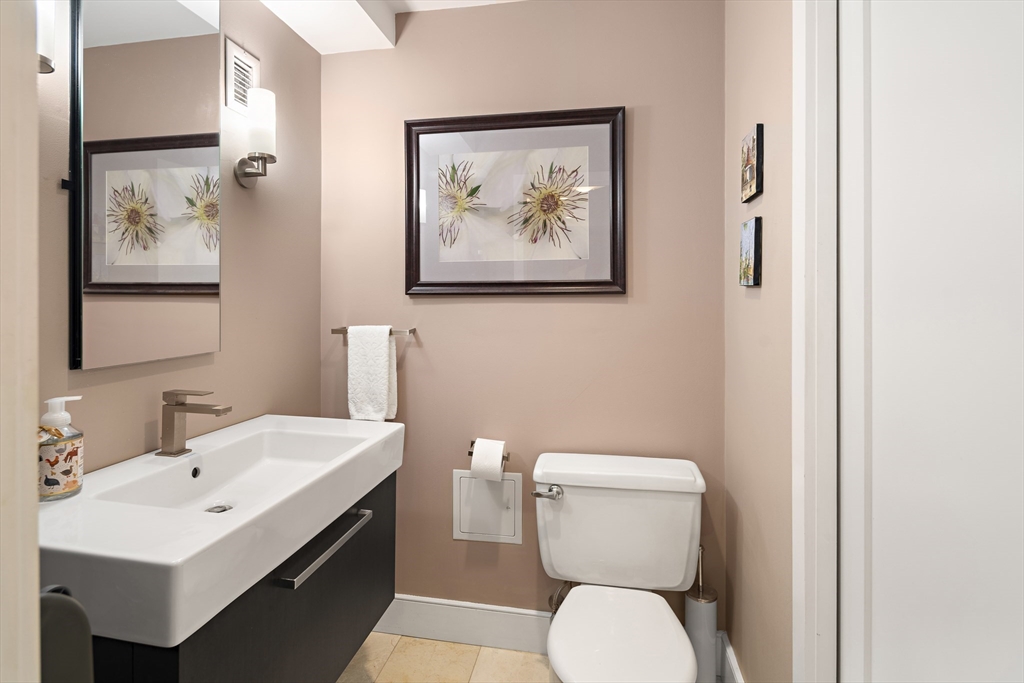 42 8th Street, Unit 5514 Boston, MA 02129 - Photo 14 of 38 a bathroom with a toilet a sink and mirror