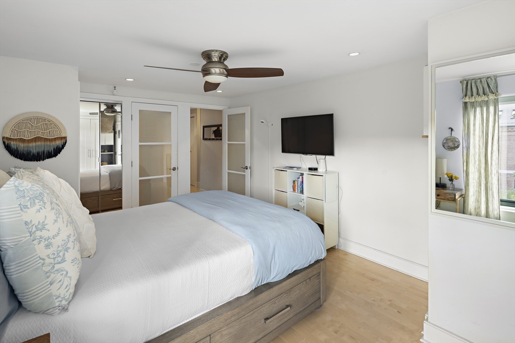 42 8th Street, Unit 5514 Boston, MA 02129 - Photo 15 of 38 a bedroom with a bed and a flat tv screen