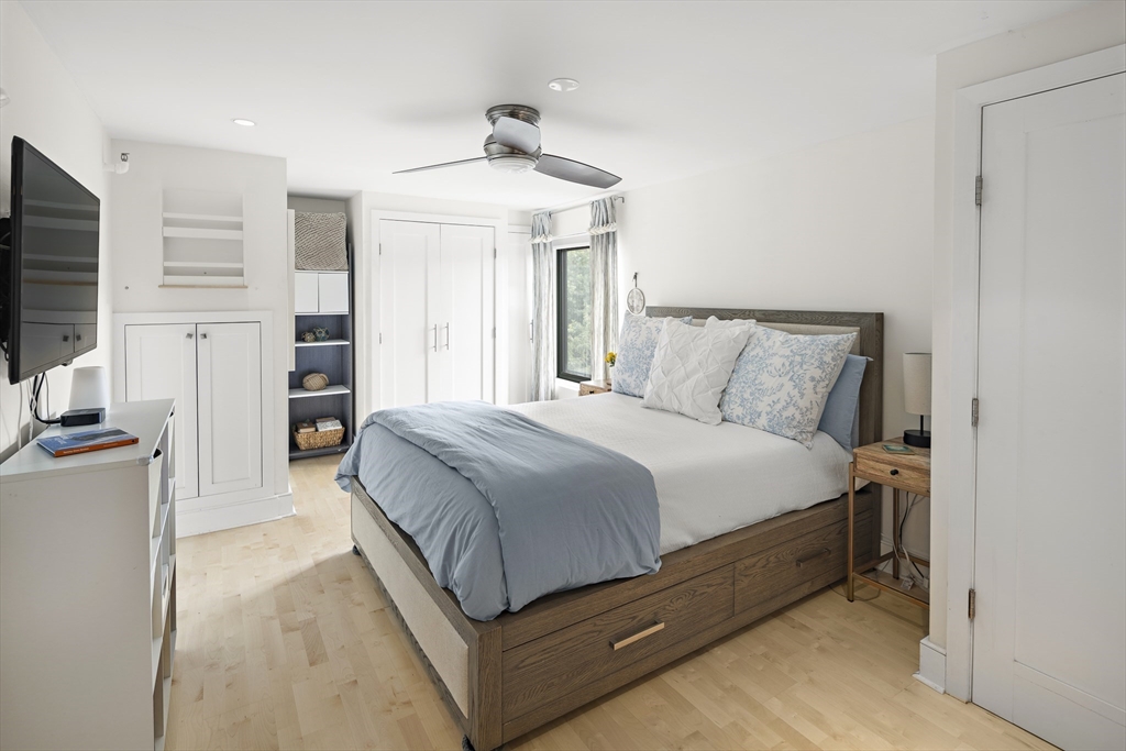 42 8th Street, Unit 5514 Boston, MA 02129 - Photo 16 of 38 a spacious bedroom with a bed and a flat screen tv