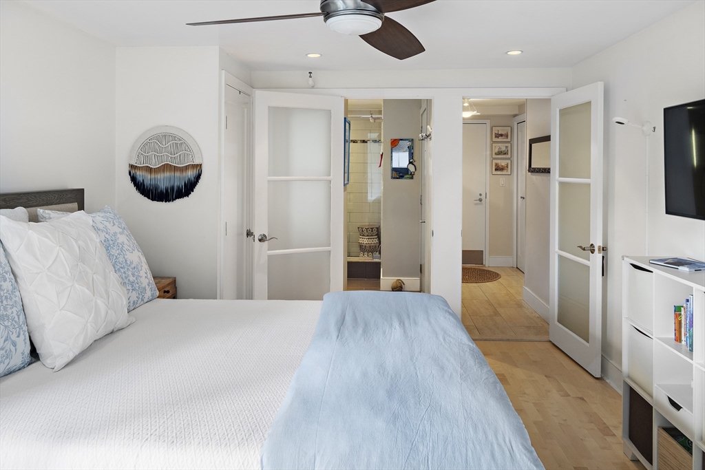 42 8th Street, Unit 5514 Boston, MA 02129 - Photo 18 of 38 a bedroom with a bed and a chandelier