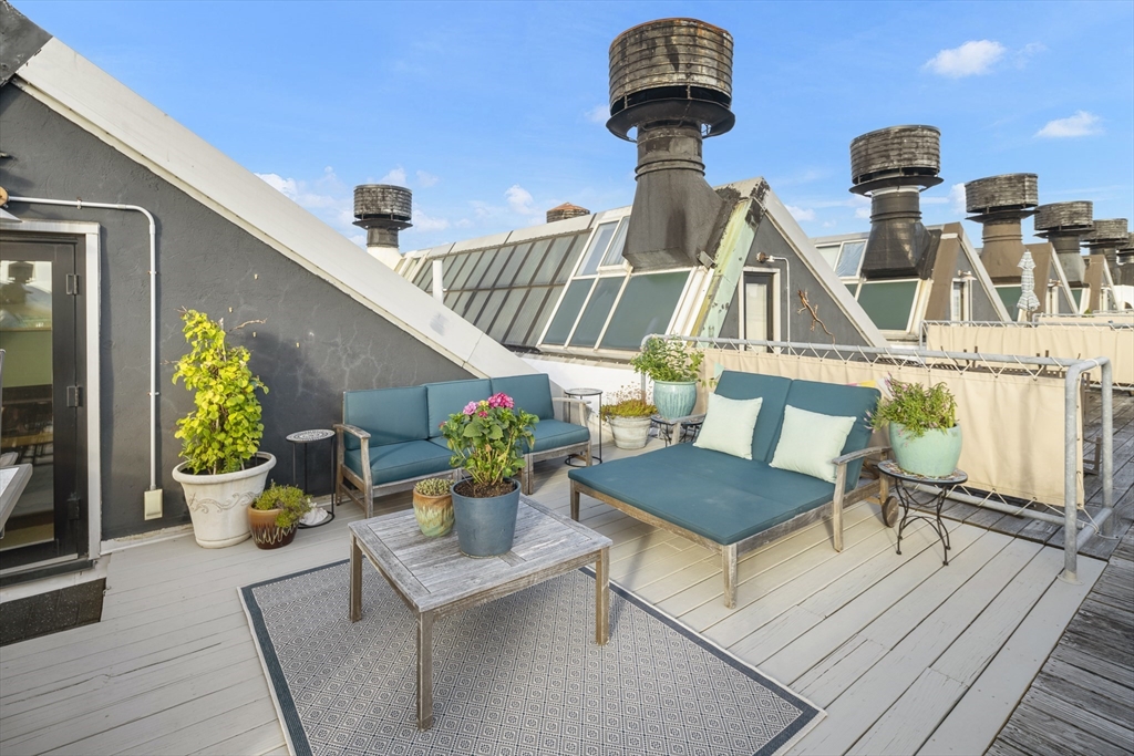 42 8th Street, Unit 5514 Boston, MA 02129 - Photo 22 of 38 a view of a chairs and table in a patio