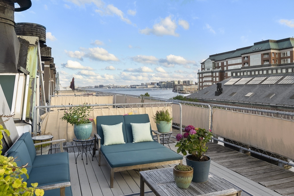 42 8th Street, Unit 5514 Boston, MA 02129 - Photo 3 of 38 a balcony with furniture and a potted plant