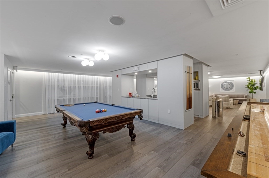 42 8th Street, Unit 5514 Boston, MA 02129 - Photo 34 of 38 a room with wooden floor pool table and windows