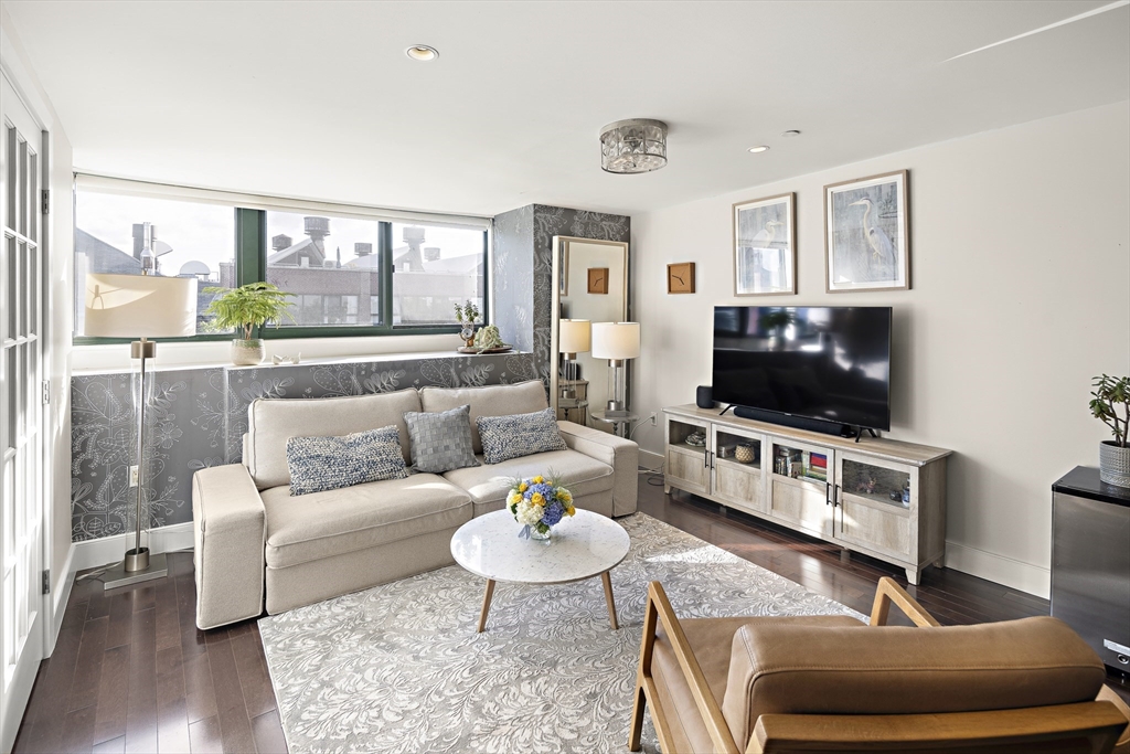 42 8th Street, Unit 5514 Boston, MA 02129 - Photo 9 of 38 a living room with furniture and a flat screen tv