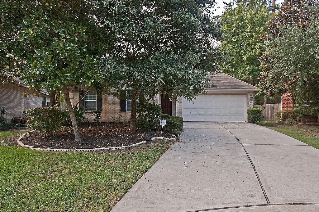 43 Steep Trail Place Conroe, TX 77385 - Photo 1 of 13 a front view of a house with a yard