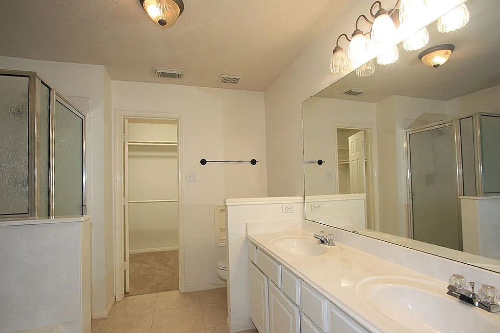 43 Steep Trail Place Conroe, TX 77385 - Photo 11 of 13 a bathroom with a sink and a mirror