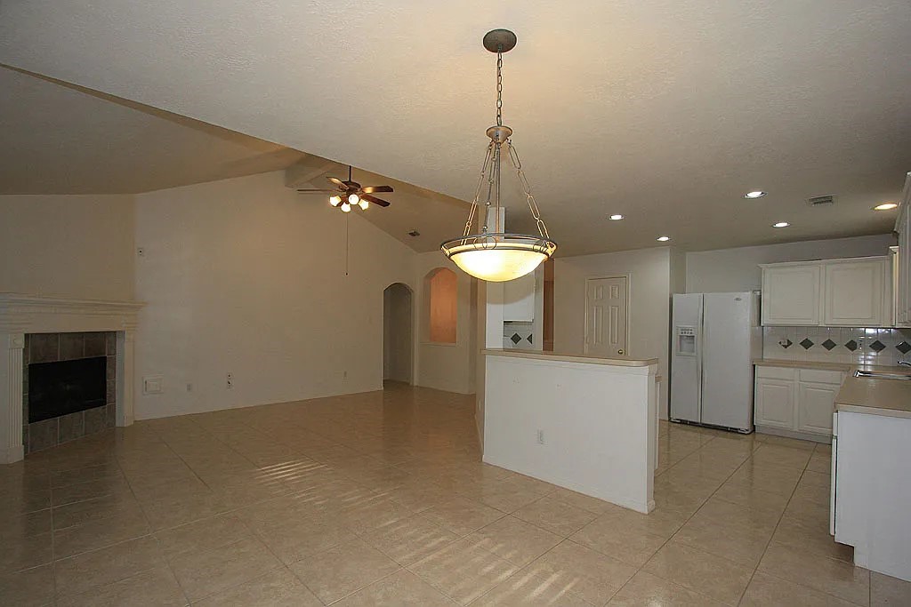 43 Steep Trail Place Conroe, TX 77385 - Photo 8 of 13 a view of a room with a stove cabinets and a floor to ceiling window