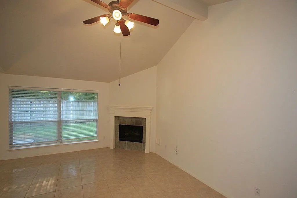 43 Steep Trail Place Conroe, TX 77385 - Photo 10 of 13 an empty room with chandelier fan and windows