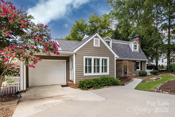 a front view of a house with a yard and a garage