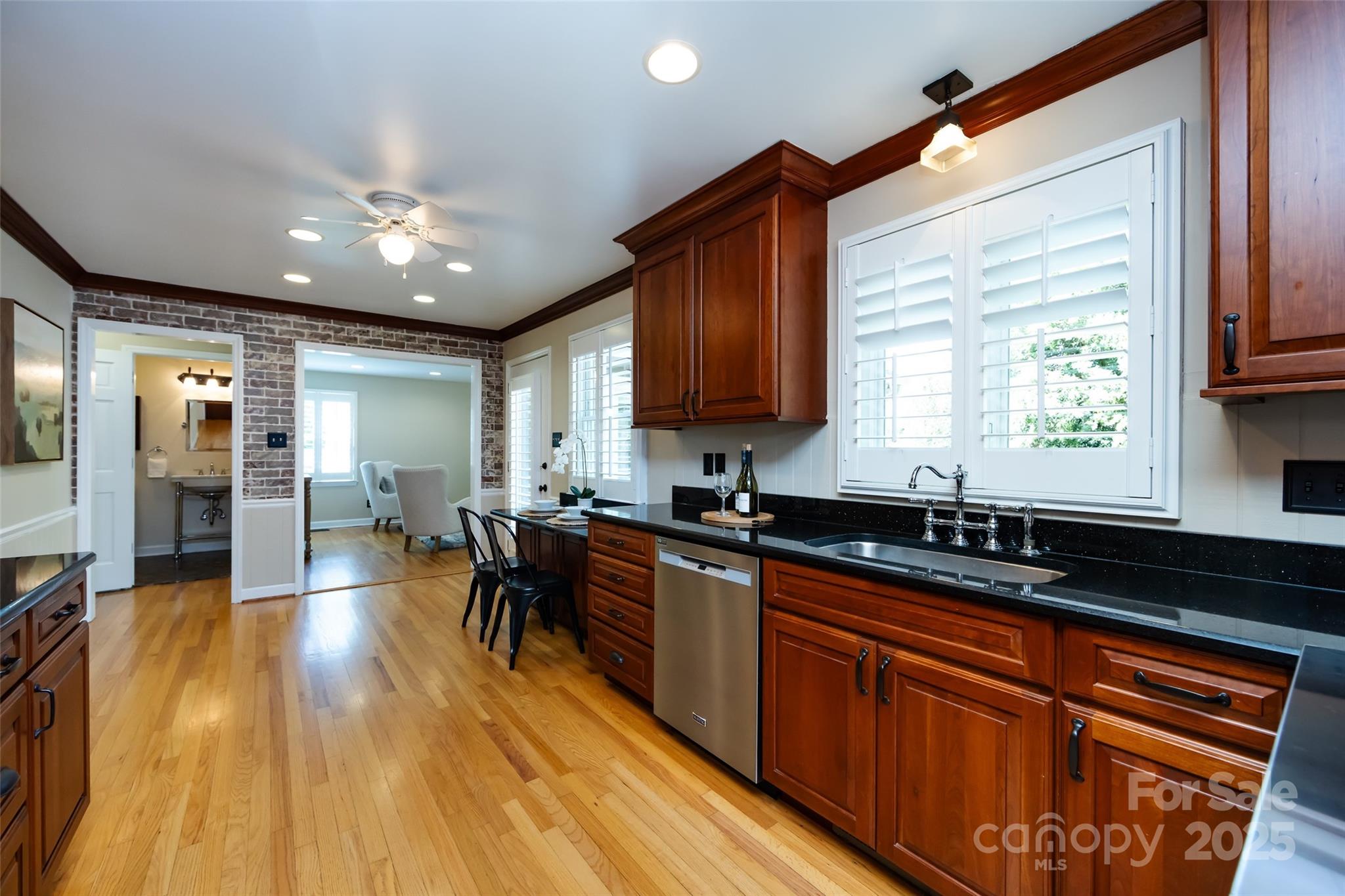 757 Concord Road Davidson, NC 28036 - Photo 13 of 46 a kitchen with stainless steel appliances granite countertop wooden floors a sink and cabinets