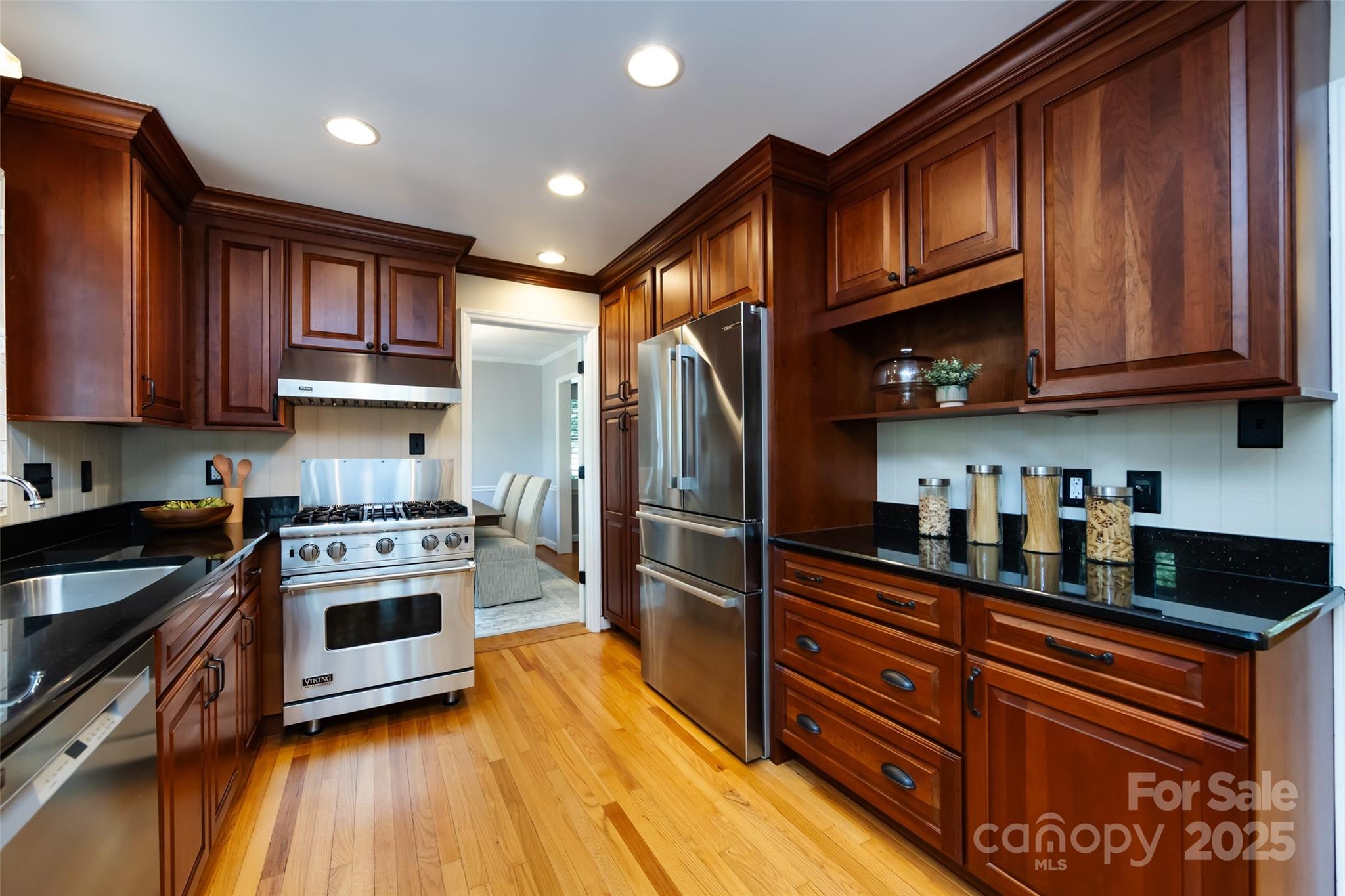 757 Concord Road Davidson, NC 28036 - Photo 15 of 46 a kitchen with stainless steel appliances granite countertop a refrigerator a stove top oven and cabinets with wooden floor