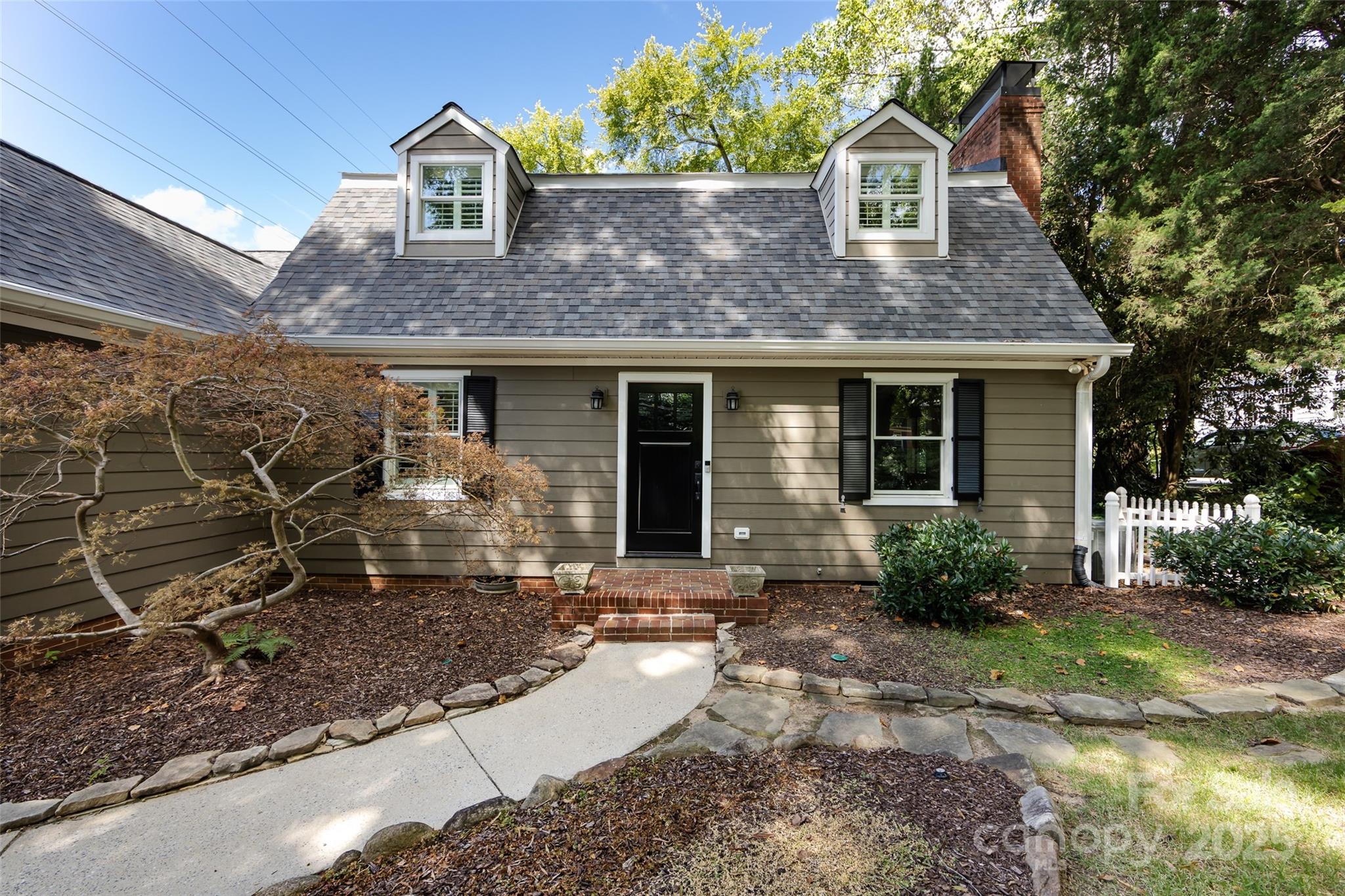 757 Concord Road Davidson, NC 28036 - Photo 2 of 46 a front view of a house with garden