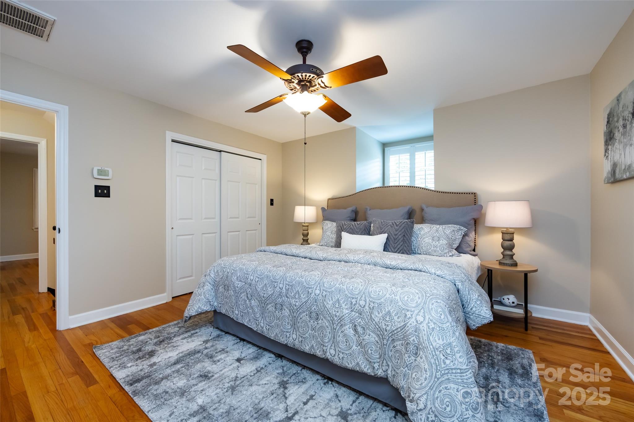 757 Concord Road Davidson, NC 28036 - Photo 27 of 46 a bedroom with a bed and a dresser with wooden floor