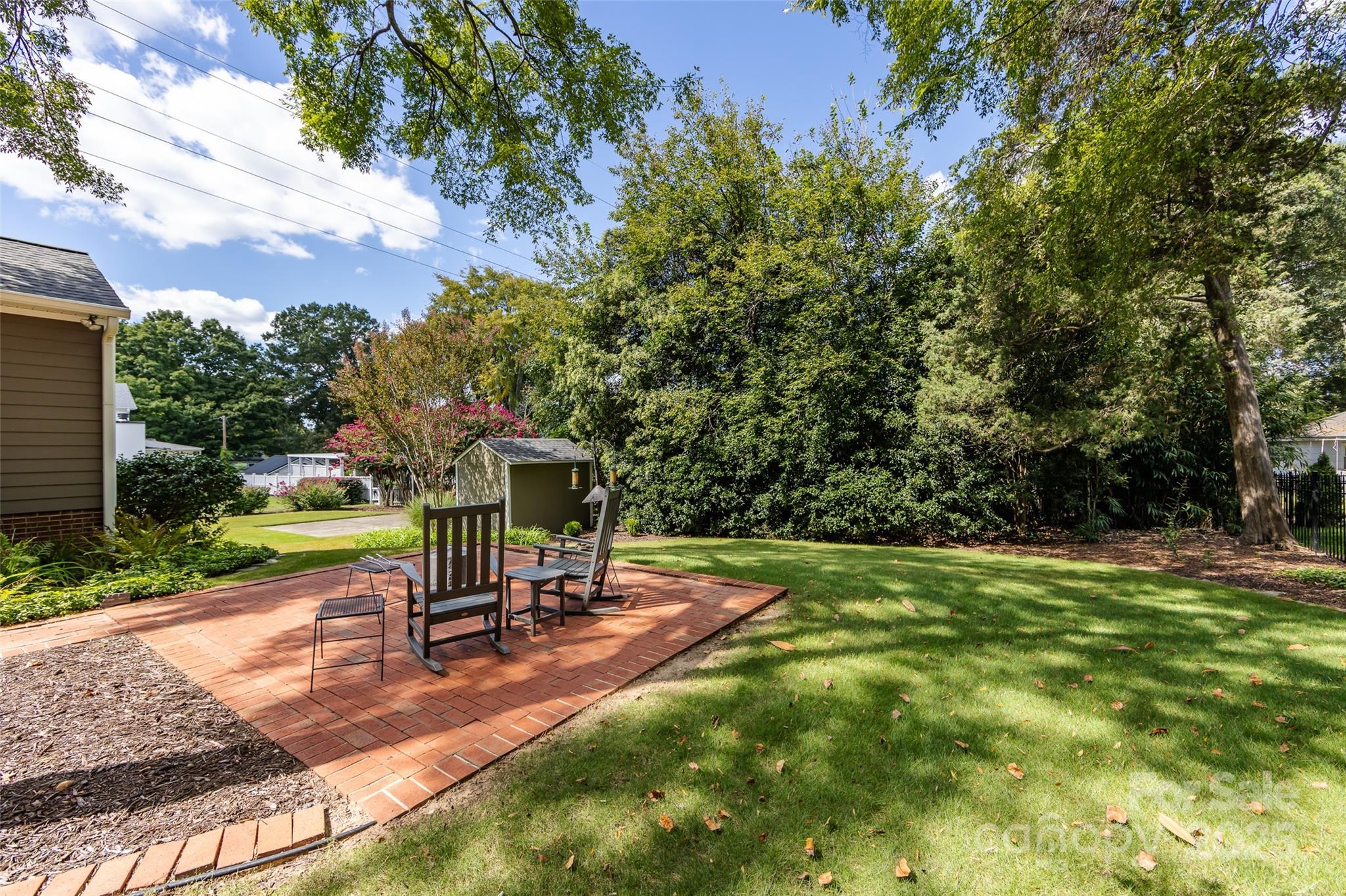 757 Concord Road Davidson, NC 28036 - Photo 40 of 46 a view of a backyard with a slide trees and a small yard