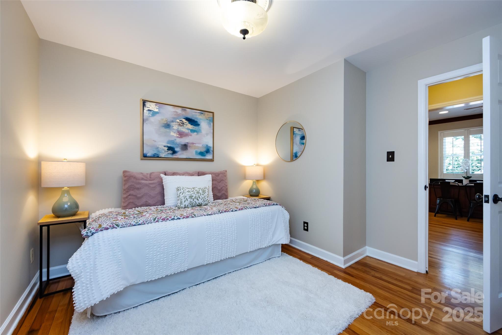 757 Concord Road Davidson, NC 28036 - Photo 7 of 46 a bedroom with a bed and wooden floor