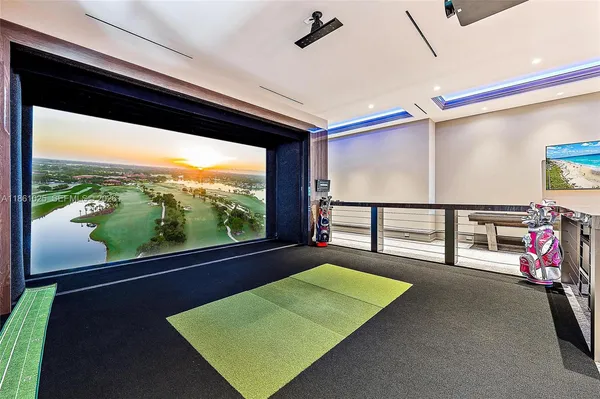 a room with pool table and windows