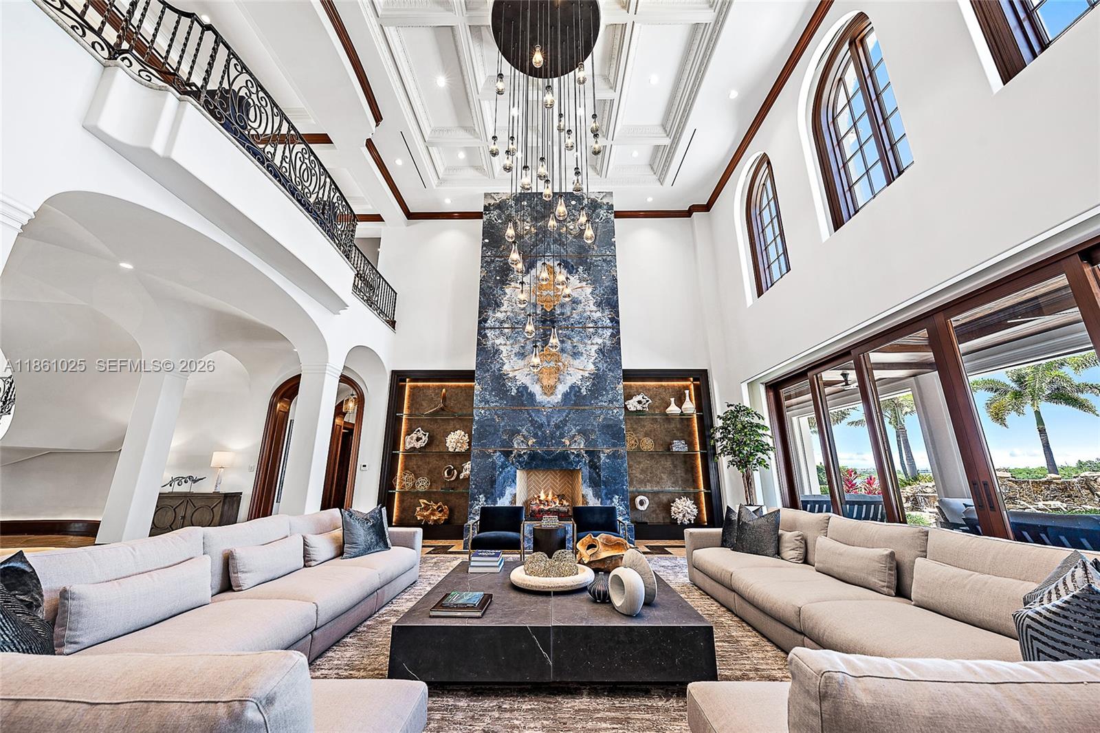 176 Spyglass Lane Jupiter, FL 33477 - Photo 20 of 79 a living room with fireplace furniture and a chandelier