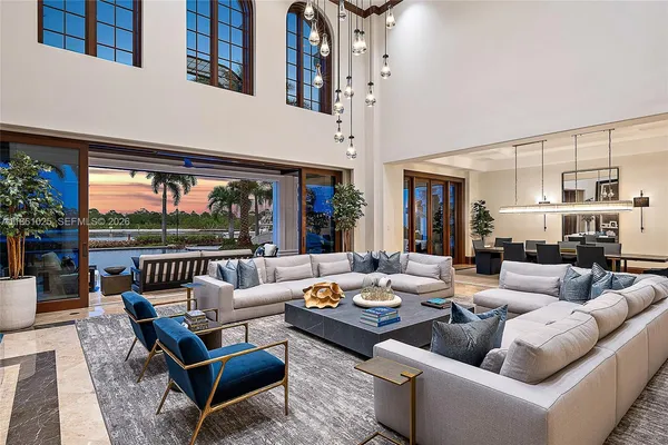 a living room with furniture fireplace and a large window