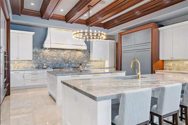 a kitchen with stainless steel appliances granite countertop a large window