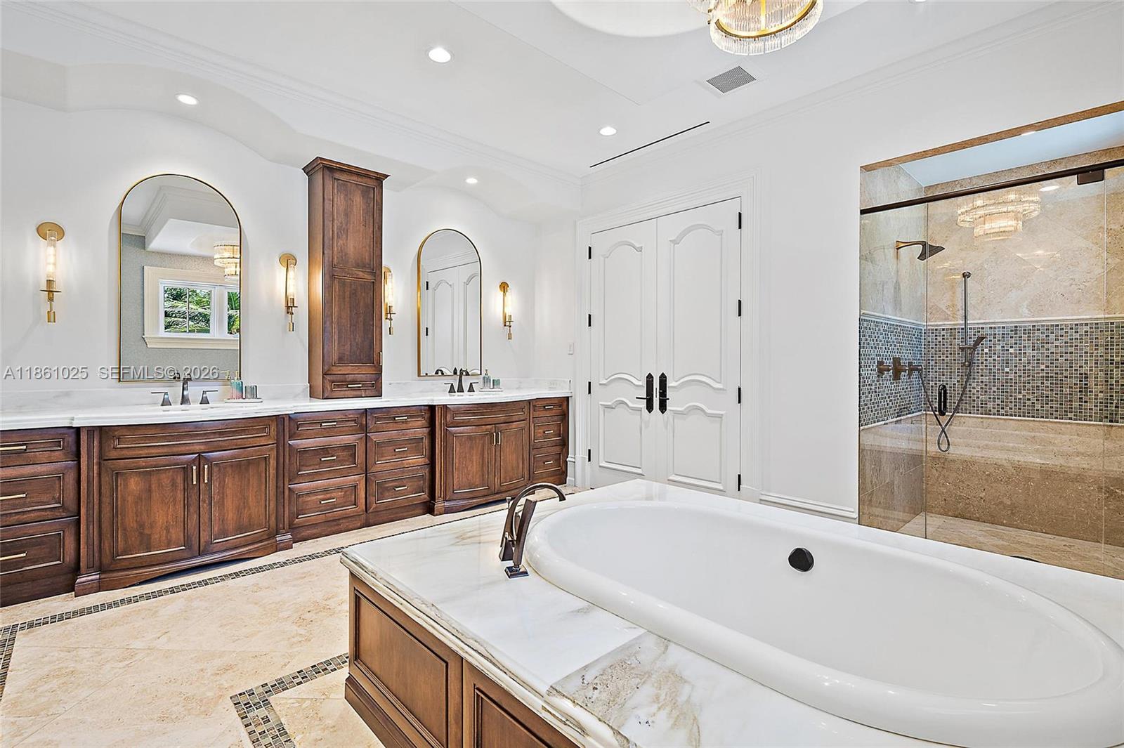 176 Spyglass Lane Jupiter, FL 33477 - Photo 58 of 79 a spacious bathroom with a granite countertop tub double vanity sink and a large mirror
