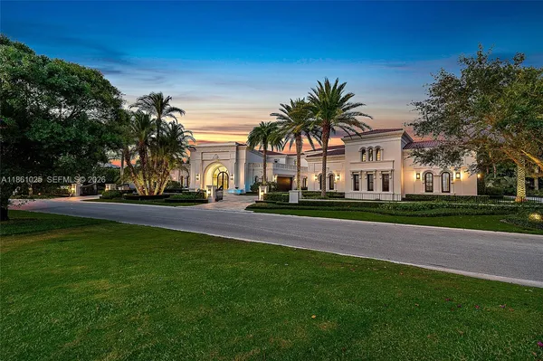 a front view of a house with a garden and plants