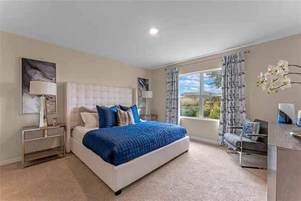 a living room with a bed furniture and a large window